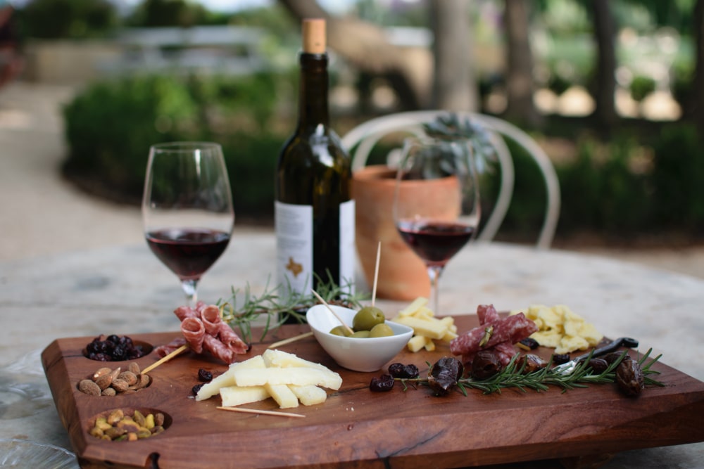 Wineries in Walla Walla, photo of an outdoor tasting with wine and charcuterie