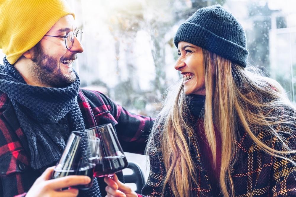 Getaway in Washington State, happy couple drinking wine in the snow